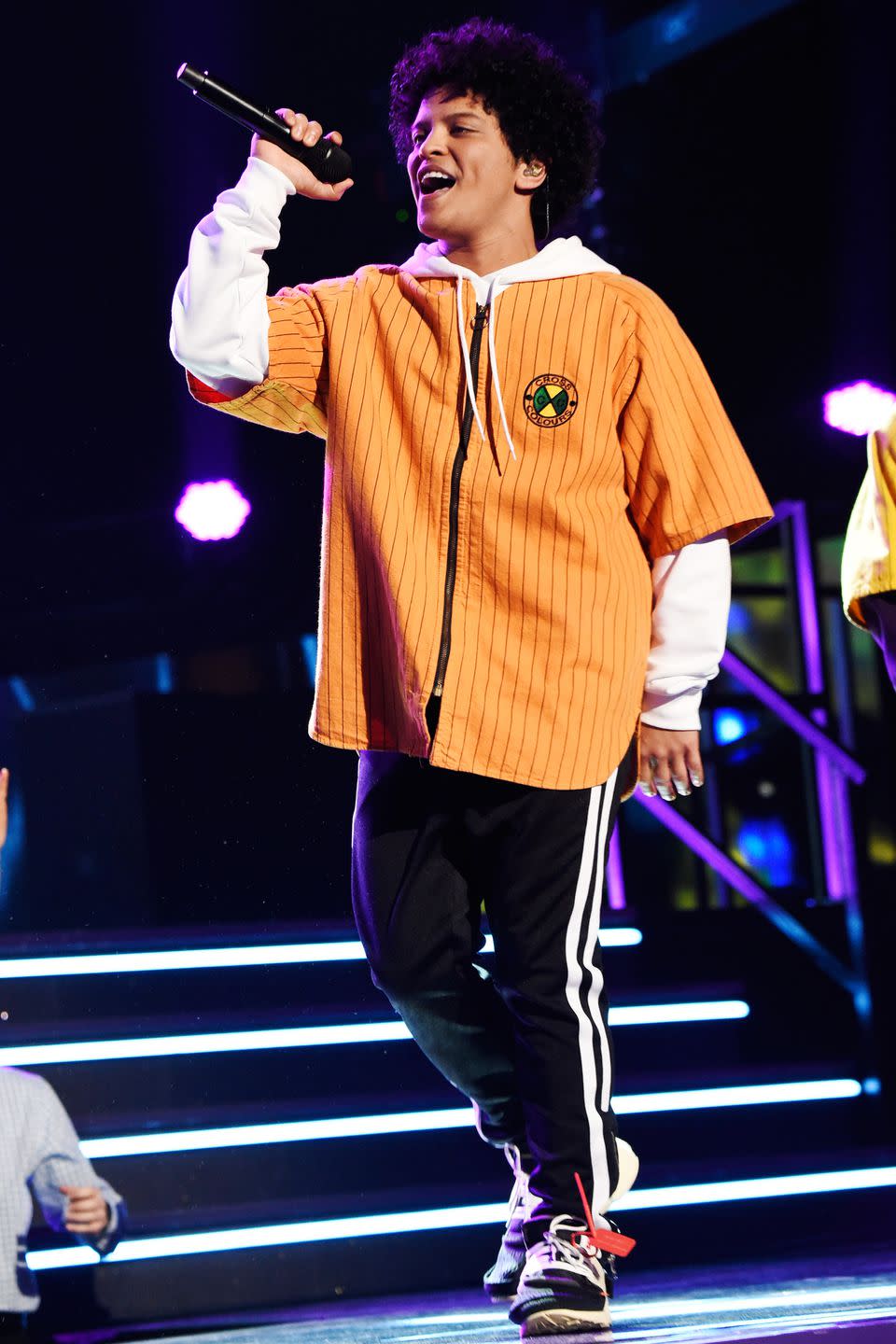 <p>An oversized orange zip-up shirt might look out of place in most situations. But on a Bruno Mars stage? Never. </p>