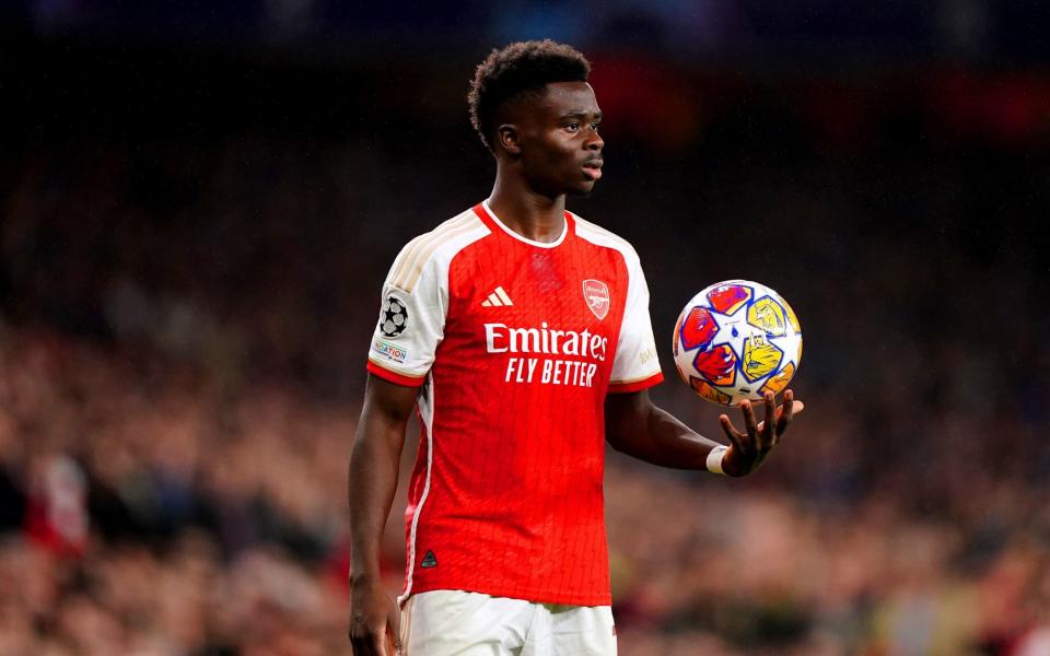 Bukayo Saka holding the ball during an Arsenal match