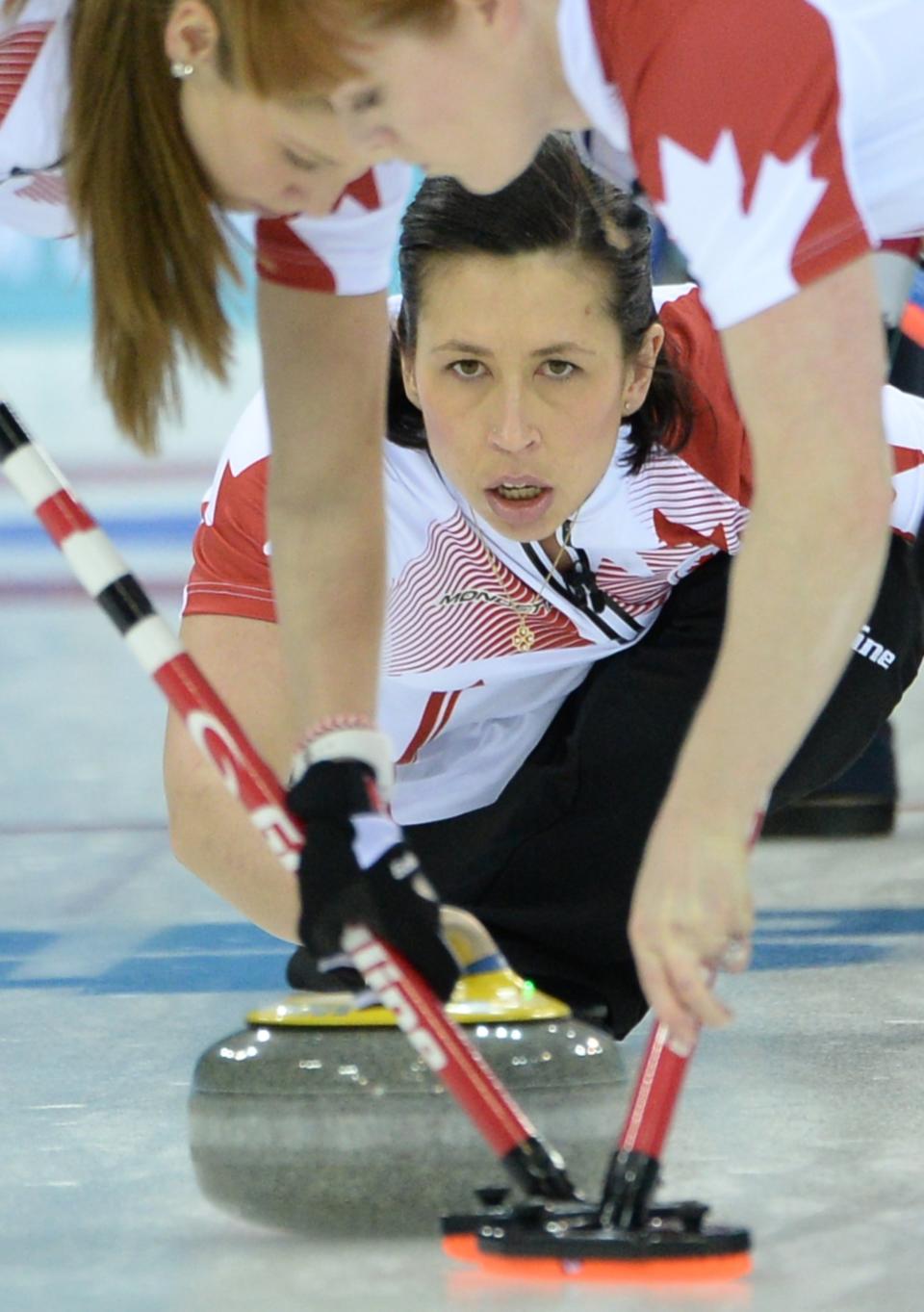 Canada's Jill Officer (C) throws the stone during the Women's Curling Gold Medal Game at the Ice Cube Curling Center during the Sochi Winter Olympics on Feb. 20, 2014.   