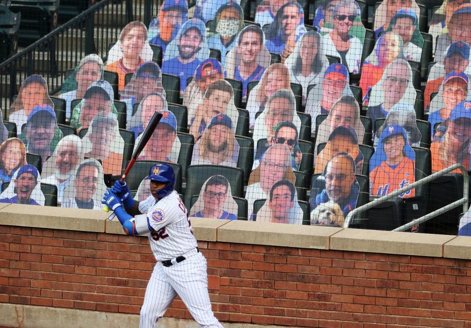<p>Yoenis Cespedes #52 of the New York Mets stands in the on deck circle in front of cardboard fans during their Pre Season game at Citi Field on July 18.</p>