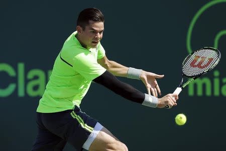 Mar 30, 2015; Key Biscayne, FL, USA; Milos Raonic hits a backhand against Jeremy Chardy (not pictured) on day eight of the Miami Open at Crandon Park Tennis Center. Raonic won 6-1, 5-7, 7-6 (3). Mandatory Credit: Geoff Burke-USA TODAY