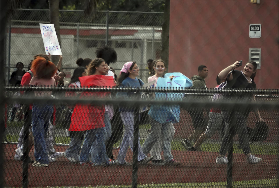 Students from Monarch High School in Coconut Creek, Fla., walk out of the school building Tuesday, Nov. 28, 2023, in support of a transgender student who plays on the girls volleyball team. The school principal and other administrators were removed from their positions for allowing the student to participate in the activity. Florida passed a law prohibiting transgendered girls to play on female sports teams. (Joe Cavaretta/South Florida Sun-Sentinel via AP)