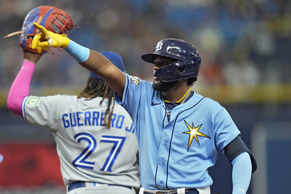 Tampa Bay Rays' Junior Caminero points at his family after hitting a single off Toronto Blue Jays starting pitcher Hyun Jin Ryu during the third inning of a baseball game Saturday, Sept. 23, 2023, in St. Petersburg, Fla. The single was Caminero's first hit of his major league career. (AP Photo/Chris O'Meara)