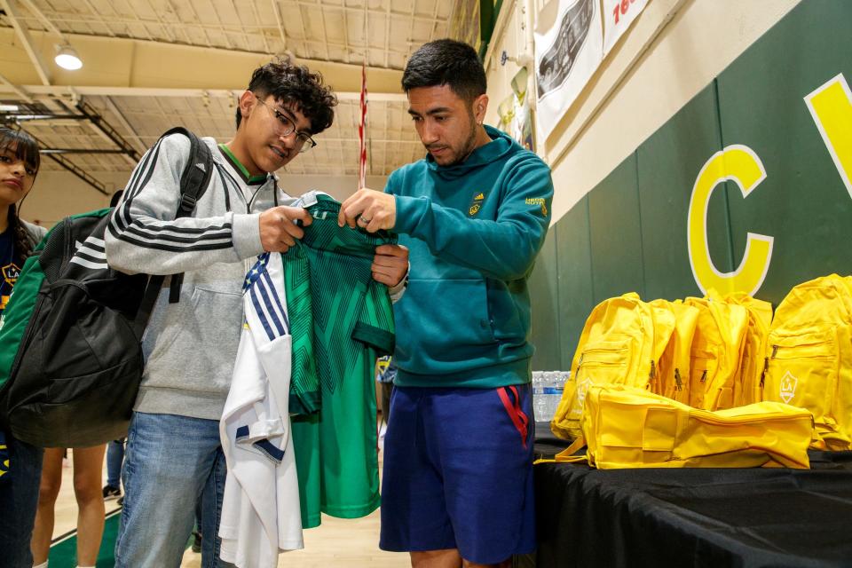 LA Galaxy midfielder Memo Rodriguez, right, autographs a shirt for West Shores High School freshman Jose Aguilar after Rodriguez spoke at Coachella Valley High School in Thermal, Calif., on Monday, Feb. 13, 2023.