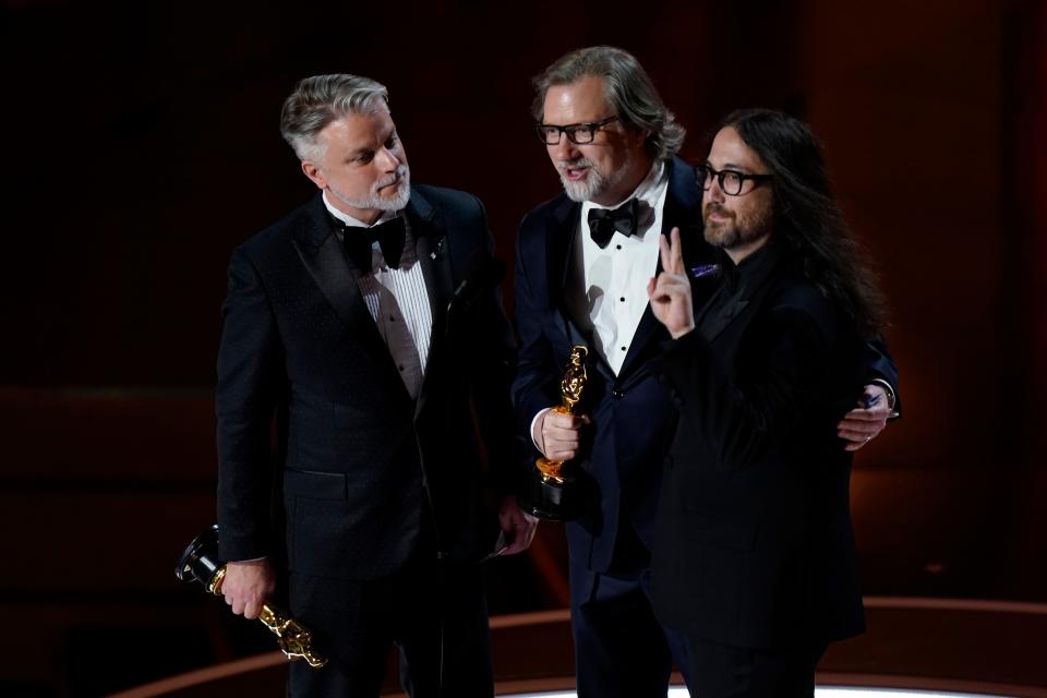 Brad Booker, from left, Dave Mullins, and Sean Ono Lennon accept the award for best animated short film for "WAR IS OVER! Inspired by the Music of John & Yoko" during the 96th Oscars at the Dolby Theatre at Ovation Hollywood in Los Angeles on March 10, 2024.