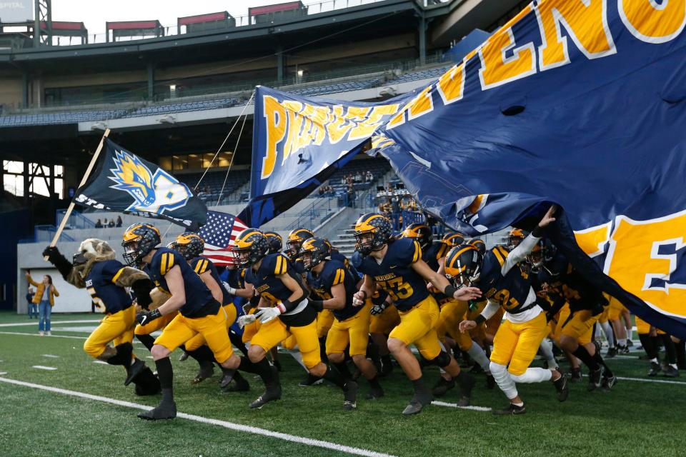 Prince Avenue runs out on the field before the GHSA Class A private high school football state championship game between Prince Avenue and Trinity Christian in Atlanta, on Thursday, Dec. 9, 2021. Trinity Christian won 55-28.