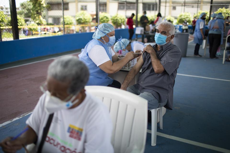 A nurse inoculates an elderly man with a dose of the Sputnik V COVID-19 vaccine at the 23 de Enero neighborhood in Caracas, Venezuela, Wednesday, June 9, 2021. ( AP Photo/Ariana Cubillos)