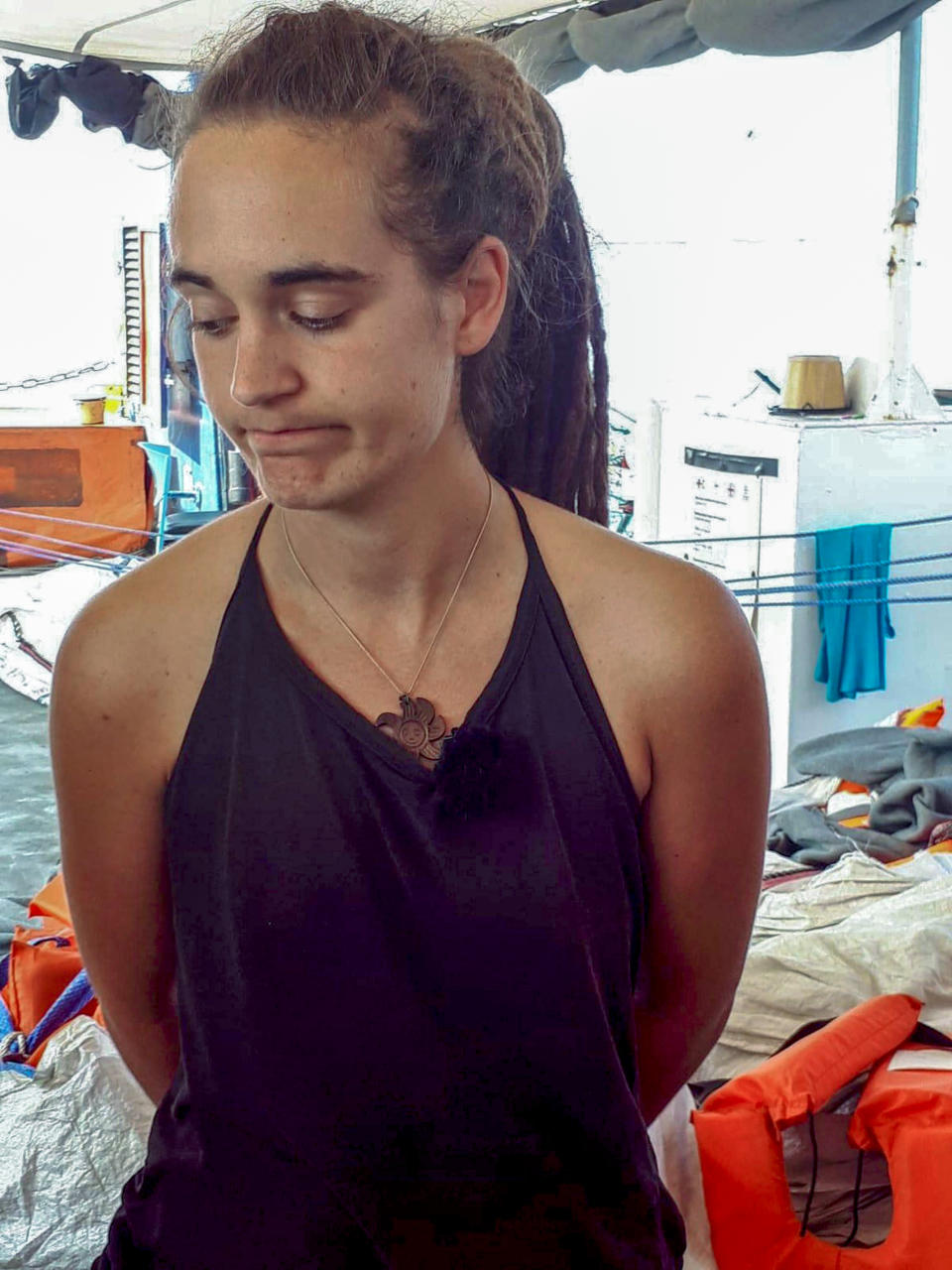 Sea-Watch 3 captain Carola Rackete is seen on board the vessel at sea in the Mediterranean, just off the coasts of the southern Italian island of Lampedusa, Thursday, June 27, 2019. The captain of the humanitarian rescue ship says that Italian law enforcement officials have told them that a resolution is near for 42 migrants rescued at sea that Italy’s populist government has so far refused to allow to disembark. (ANSA/Matteo Guidelli via AP)