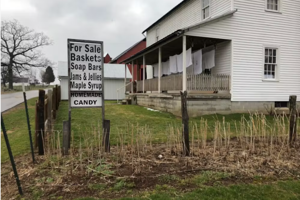 A farmhouse with a sign advertising tourist wares.