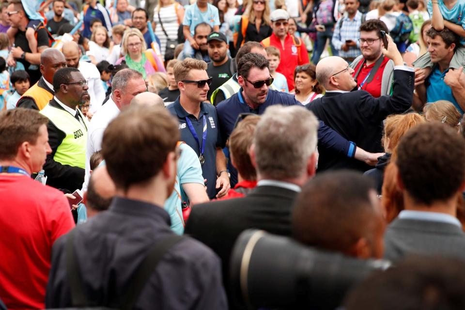 The cricketers push through the throng at The Oval to celebrate with their trophy (Action Images via Reuters)