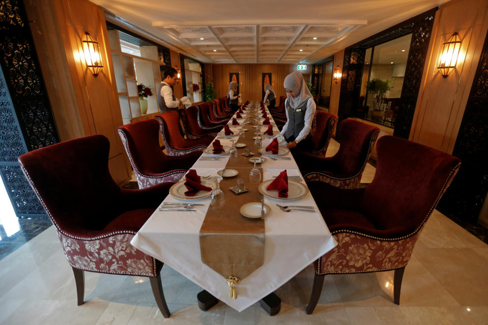 Muslim employees arrange a table at the Al Meroz hotel in Bangkok