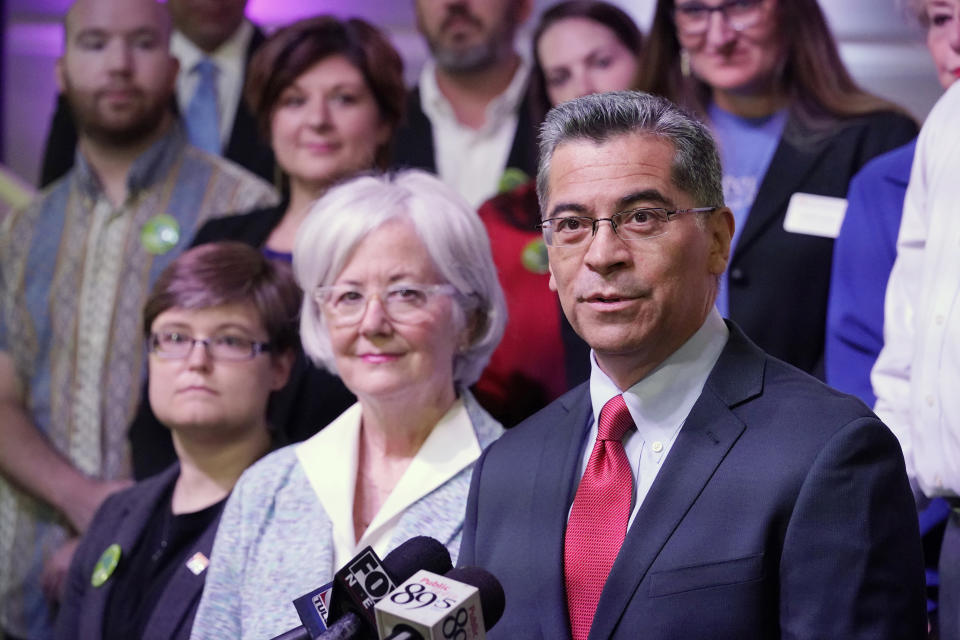 U.S. Department of Health and Human Services (HHS) Secretary Xavier Becerra, right, speaks while surrounded by Oklahoma Medicaid advocates Thursday, July 1, 2021, in Tulsa, Okla., as Oklahoma expands its Medicaid program. (AP Photo/Sue Ogrocki)