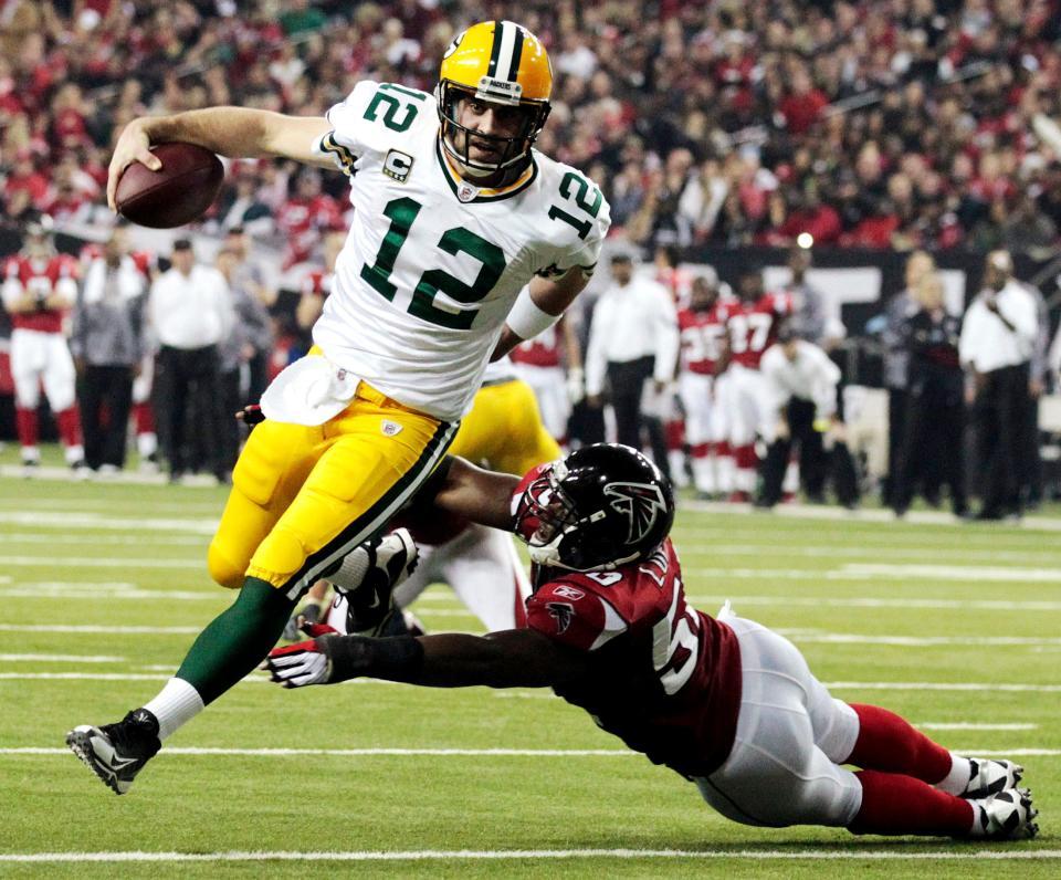 Green Bay Packers quarterback Aaron Rodgers scrambles past Atlanta Falcons linebacker Curtis Lofton on a 7-yard touchdown run during the second half of a divisional playoff football game in Atlanta.