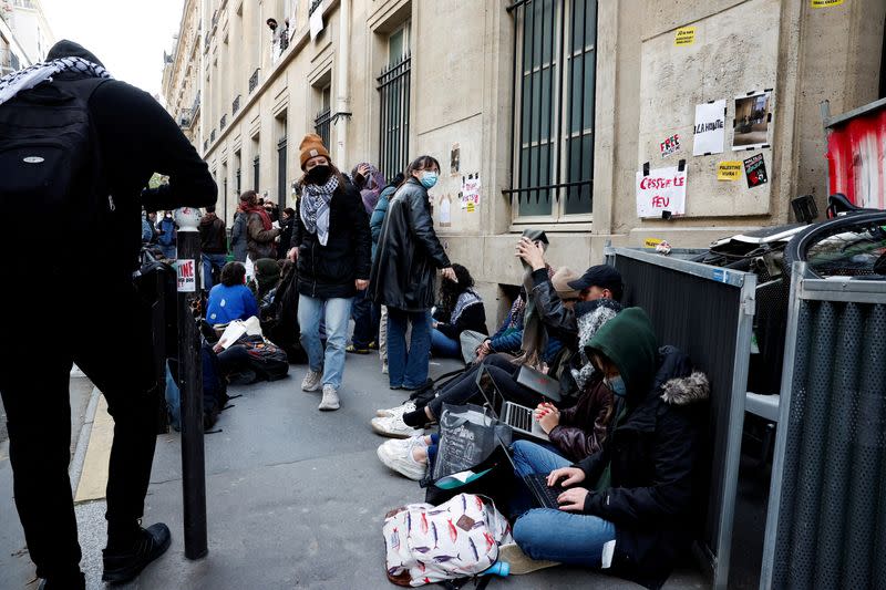 Masked youths take part in the occupation of a building of the Sciences Po University in support of Palestinians in Gaza, in Paris