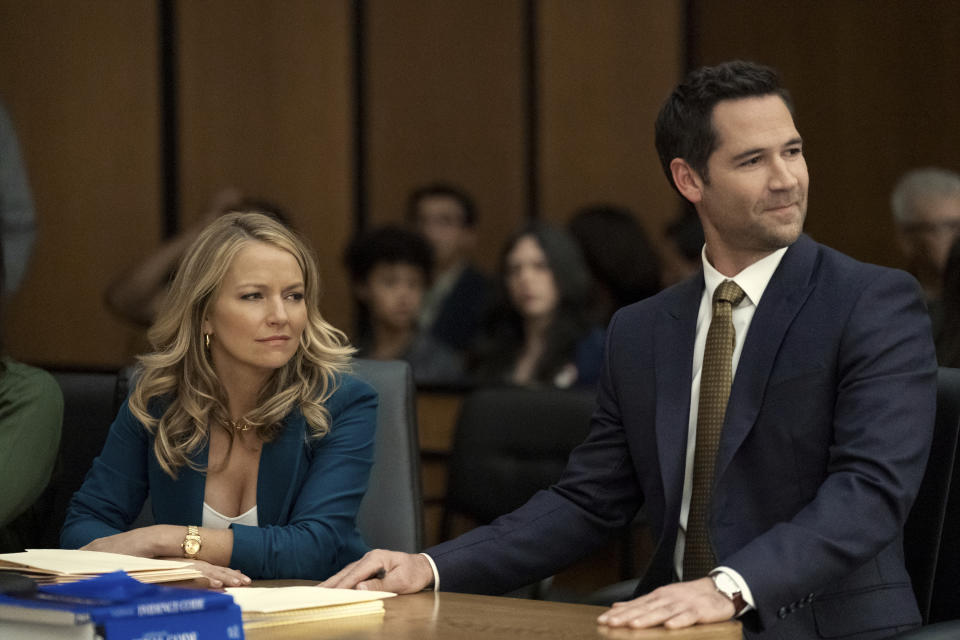 This image released by Netflix shows Becki Newton, left, and Manuel Garcia-Rulfo in a scene from "The Lincoln Lawyer." (Lara Solanki/Netflix via AP)