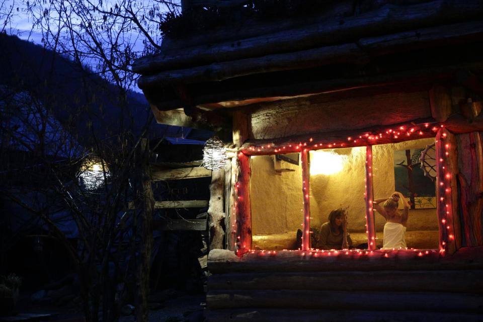 Olga Gharkova, right, and Svetlana Fedorenko sit in a tea room at the British Banya bathhouse, Saturday, Feb. 15, 2014, in Krasnaya Polyana, Russia. The banya is an institution in Russia. Businessmen make deals there, romantic comedies are set in the banya. Russians even have a specific greeting for each other as they emerge from the steam room: "Happy light steam!" (AP Photo/Jae C. Hong)