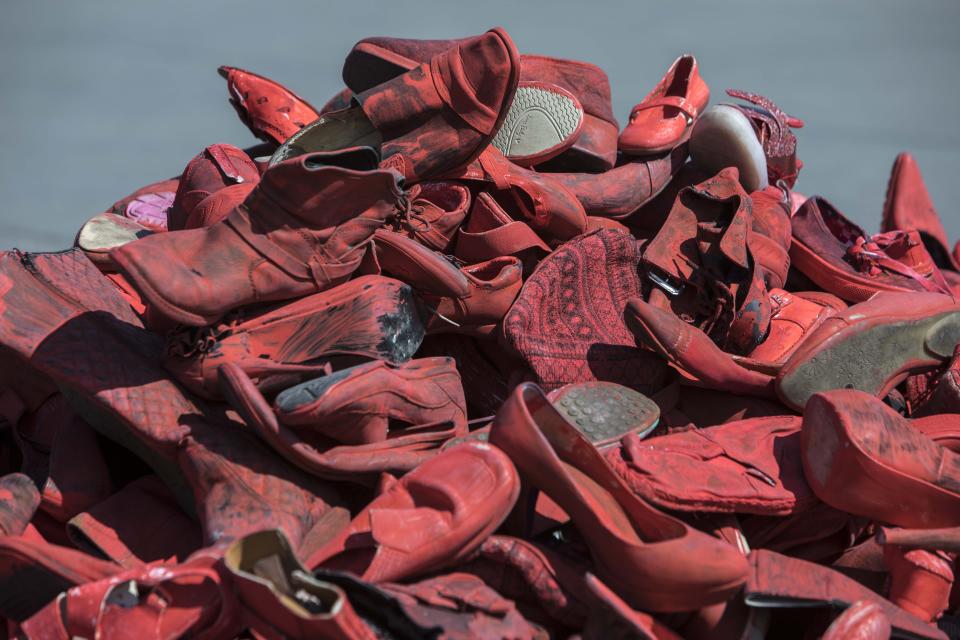 Women's red shoes are piled up in the Zocalo where they were placed by people to protest violence against women in Mexico City, Saturday, Jan. 11, 2020. There are 10 women killed daily on average across Mexico, and only one in 10 such crimes are solved, according to the National Citizens’ Observatory on Femicide. (AP Photo/Christian Palma)