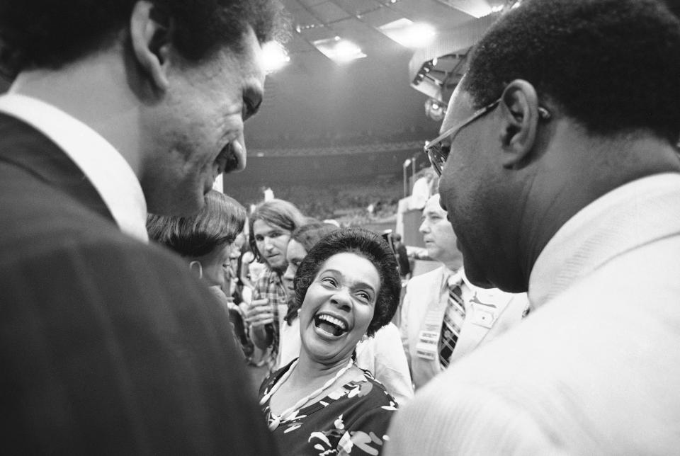 FILE - Coretta King, widow of the Rev. Martin Luther King, smiles as she returns to the floor after addressing the Democratic National Convention at New York Tuesday, July 13, 1976. (AP Photo/Bob Daugherty, File)