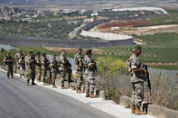 Lebanese army soldiers deploy at the Lebanese side of the Lebanese-Israeli border in the southern village of Kfar Kila, Lebanon, Saturday, May 15, 2021. (AP Photo/Hussein Malla)