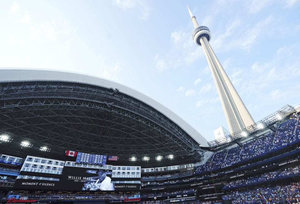 Players and fans observe a moment of silence for Willie Mays, who died Tuesday, before a baseball game between the Boston Red Sox and the Toronto Blue Jays on Wednesday, June 19, 2024, in Toronto. (Nathan Denette/The Canadian Press via AP)