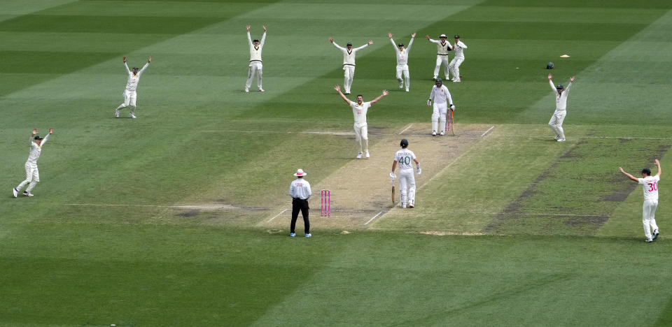 Australia's Josh Hazlewood, center, has all his teammates appeal for a LBW decision on South Africa's Heinrich Klaasen, fourth right, during the fourth day of their cricket test match at the Sydney Cricket Ground in Sydney, Saturday, Jan. 7, 2023. (AP Photo/Rick Rycroft)