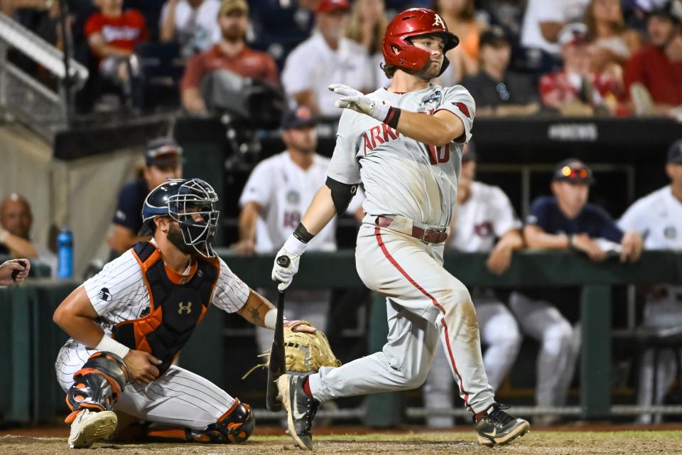 Jun 21, 2022; Omaha, NE, USA;  Arkansas Razorbacks first baseman Peyton Stovall (10) drives in two runs against the Auburn Tigers in the ninth inning at Charles Schwab Field. Mandatory Credit: Steven Branscombe-USA TODAY Sports