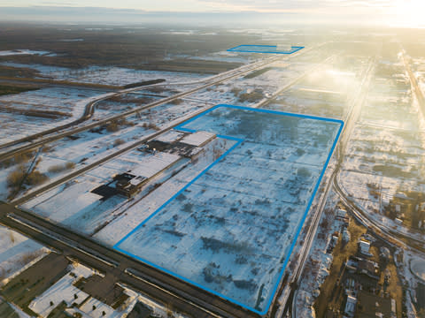 Aerial photo of the Bécancour industrial park showing NMG’s land for its Phase-2 Bécancour Battery Material Plant at the front and GM’s Ultium CAM plant at the back. (Photo: Business Wire)