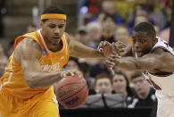 Tennessee forward Jarnell Stokes (5) vies for a loose ball against Massachusetts' Cady Lalanne during the first half of an NCAA college basketball second-round tournament game, Friday, March 21, 2014, in Raleigh, N.C. (AP Photo/Chuck Burton)