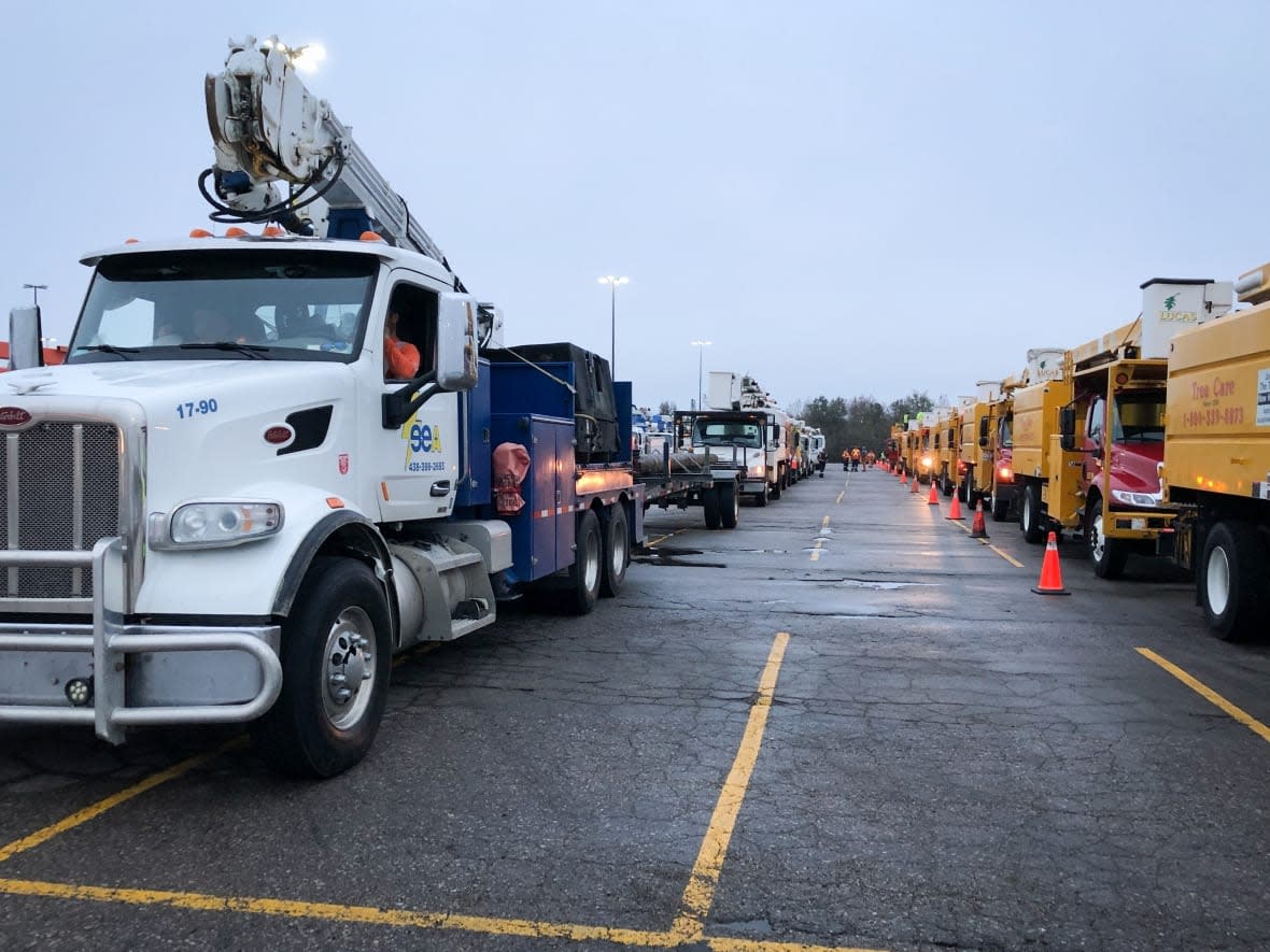 Tree-clearing contractors and utility trucks from neighbouring provinces and states stage at Mayflower Mall in Sydney, N.S. (Tom Ayers/CBC - image credit)