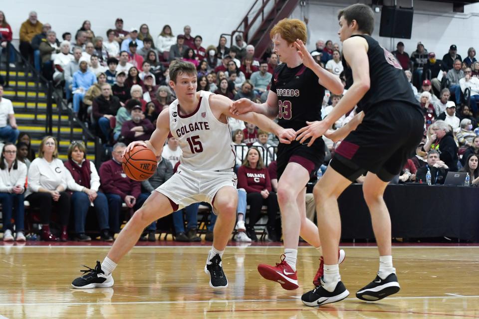 Colgate guard Tucker Richardson, left, is defended by two Lafayette players.