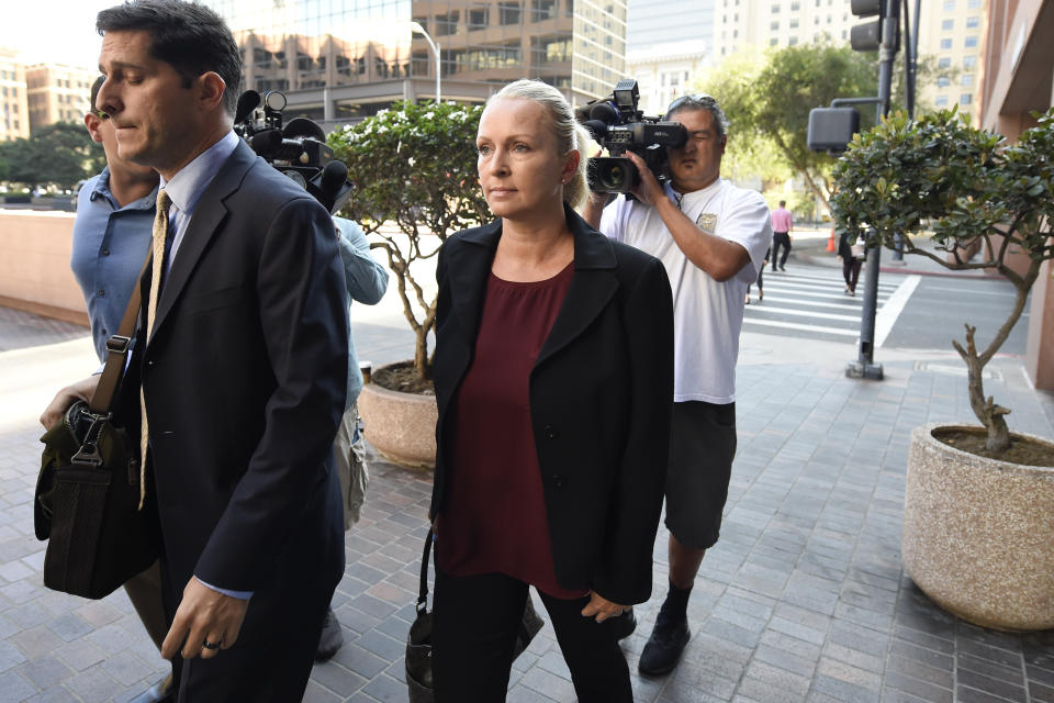 Margaret Hunter, center, the wife of U.S. Rep. Duncan Hunter, arrives for an arraignment hearing Thursday, Aug. 23, 2018, in San Diego. Hunter and his wife were indicted this week on federal charges that they used more than $250,000 in campaign funds for personal expenses that ranged from groceries to golf trips and lied about it in federal filings, prosecutors said. (AP Photo/Denis Poroy)