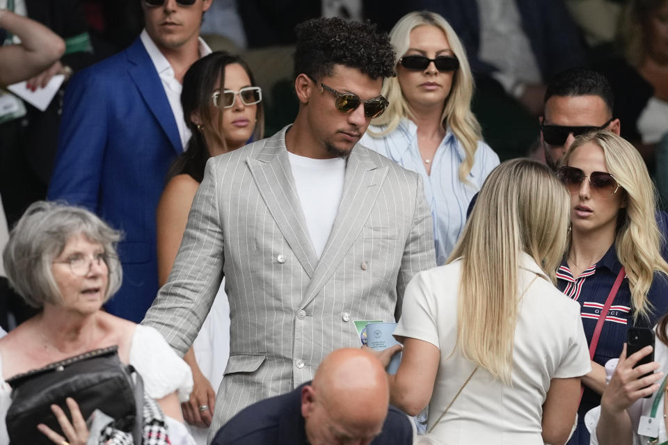 Patrick Mahomes and his wife Brittany, right, arrive on Centre Court for the third round matches at the Wimbledon tennis championships in London, Friday, July 5, 2024. (AP Photo/Alberto Pezzali)