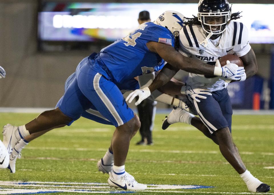 Utah State running back Rahsul Faison, right, runs against Air Force linebacker Johnathan Youngblood, left, during the second half of an NCAA college football game in Air Force Academy, Colo., Friday, Sept. 15, 2023. | Christian Murdock/The Gazette via AP