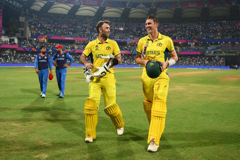 MUMBAI, INDIA - NOVEMBER 07: Glenn Maxwell of Australia celebrates with team mate Pat Cummins after hitting a six for the winning runs, finishing unbeaten on 201 not out during the ICC Men's Cricket World Cup India 2023 between Australia and Afghanistan at Wankhede Stadium on November 07, 2023 in Mumbai, India. (Photo by Alex Davidson-ICC/ICC via Getty Images)