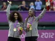 <p>Serena Williams, left, and Venus Williams of the United States smile and wave from the podium after receiving their gold medals in women’s doubles at the London Summer Olympics. (AP)</p>