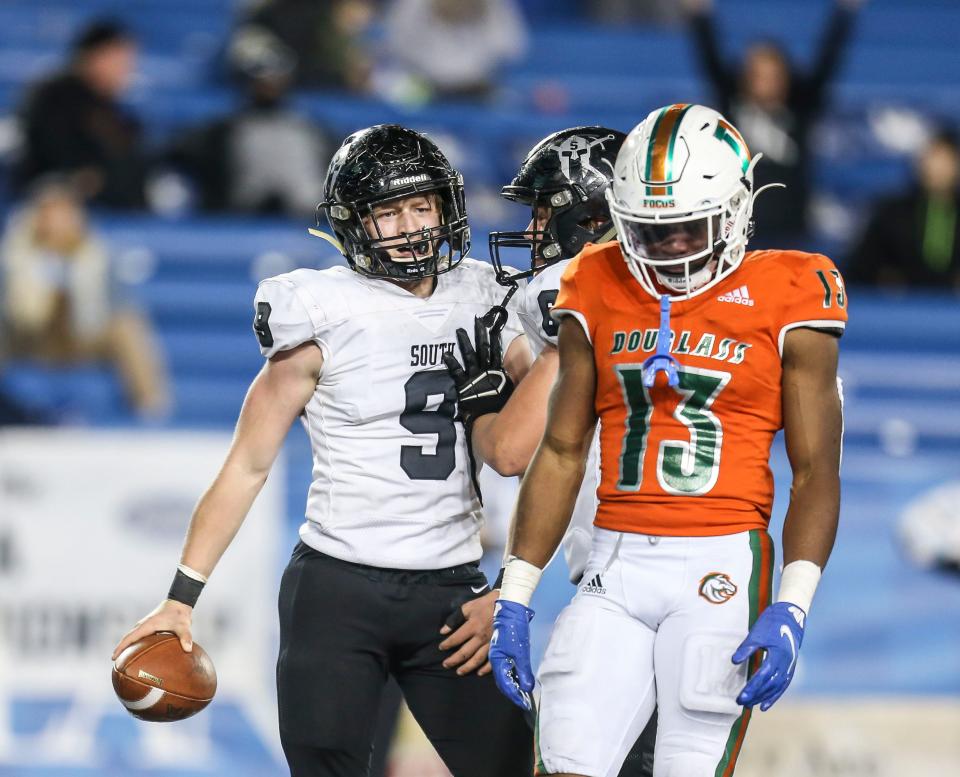 South Warren's Tyler Snell celebrates his late fourth quarter touchdown behind Frederick Douglass' Ty Bryant in the 5A KHSAA football championship Saturday. Dec.3, 2021 