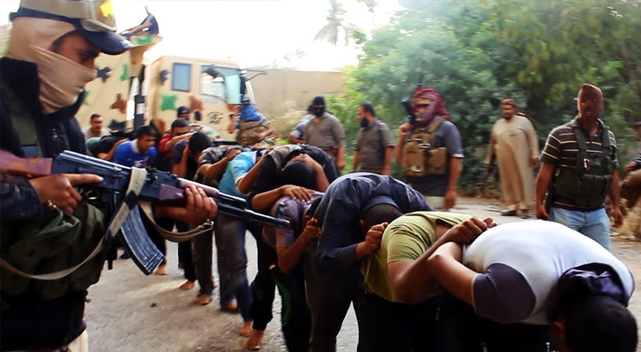 CLICK IMAGE for slideshow: An image uploaded on June 14, 2014 on the jihadist website Welayat Salahuddin allegedly shows militants of the Islamic State of Iraq and the Levant (ISIL) capturing dozens of Iraqi security forces members in Salaheddin province (AFP Photo/)