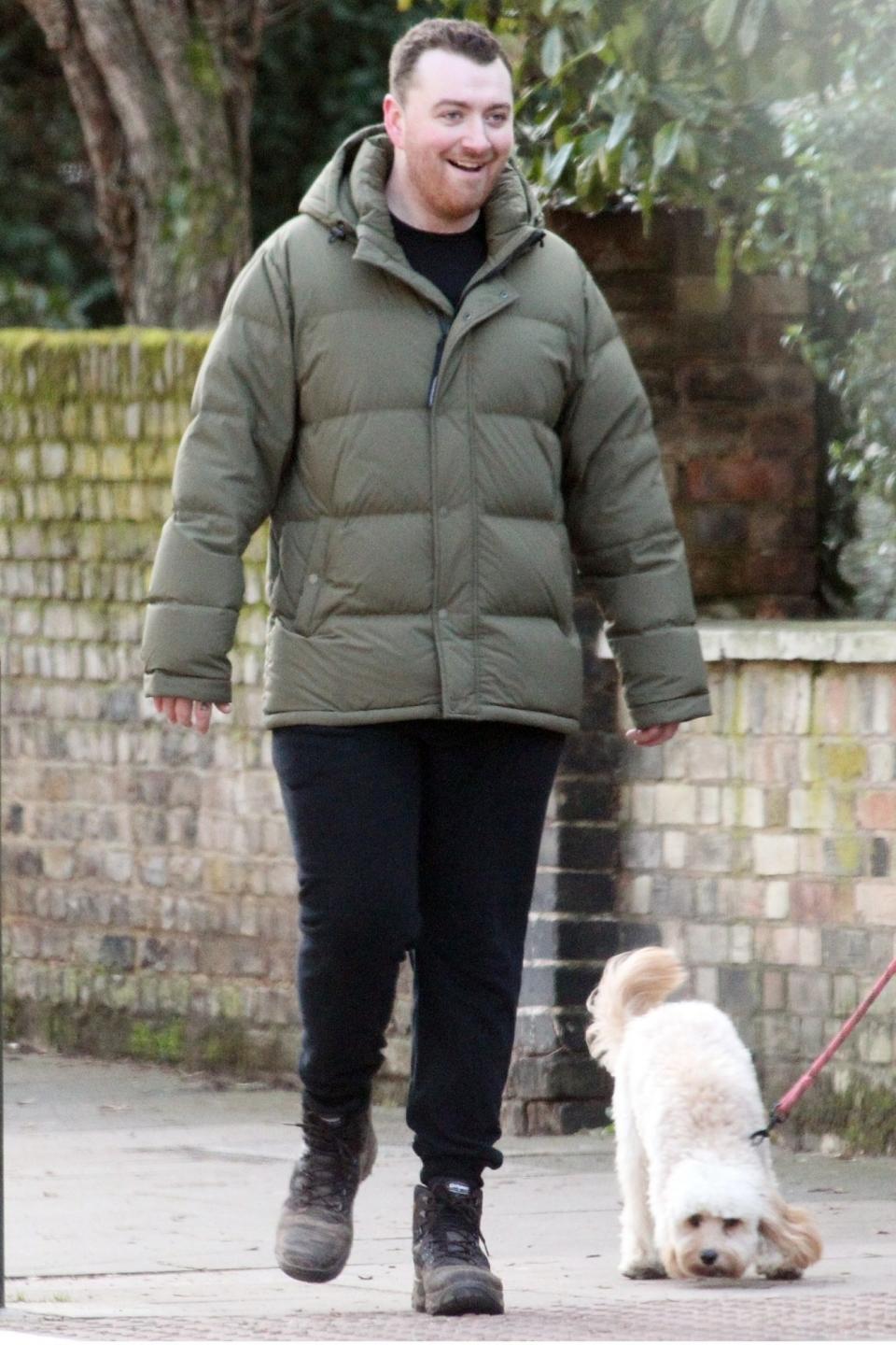 <p>Sam Smith and his puppy get some fresh air while on a walk through Hampstead, London on Thursday.</p>