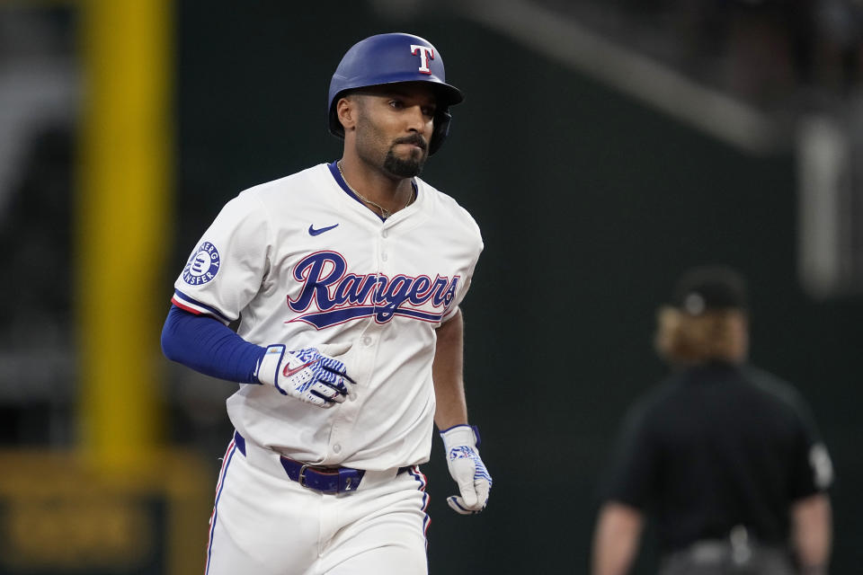 Texas Rangers' Marcus Semien rounds the bases after hitting a two-run home run against the Tampa Bay Rays in the seventh inning of a baseball game in Arlington, Texas, Saturday, July 6, 2024. (AP Photo/Tony Gutierrez)