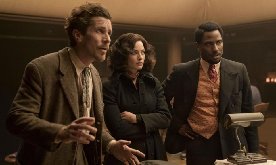 This image released by 20th Century Studios shows, from left, Christian Bale, Margot Robbie and John David Washington in a scene from “Amsterdam.” (Merie Weismiller Wallace/20th Century Studios via AP)