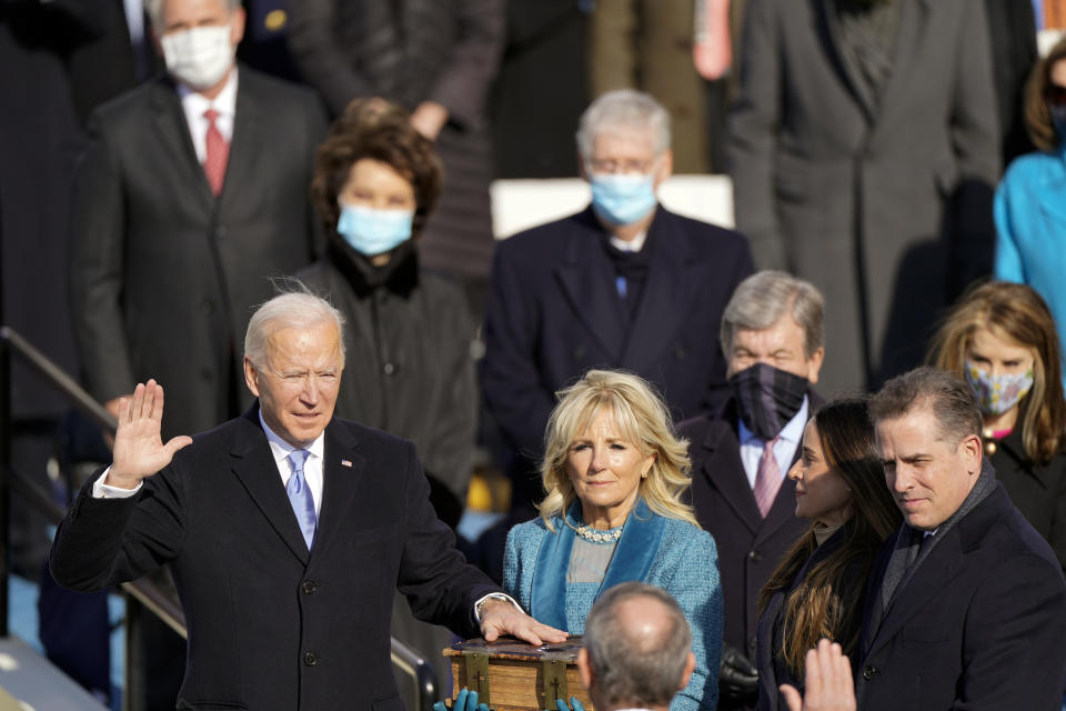 Joe Biden is sworn in as the 46th president of the United States by Chief Justice John Roberts as Jill Biden holds the Bible during the 59th Presidential Inauguration at the U.S. Capitol in Washington, Wednesday, Jan. 20, 2021, and children Ashley and Hunter watch (AP Photo/Andrew Harnik)