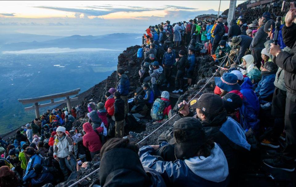 Tourists enjoy a sunset view from Mt. Fuji, in an image provided by the administration of Japan's Yamanashi prefecture. / Credit: Handout/Yamanashi prefecture