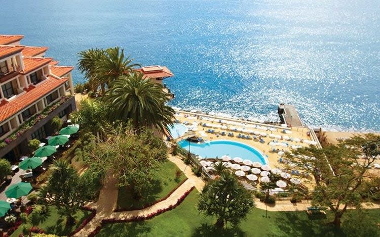 aerial view of hotel, lawns, beach and pool