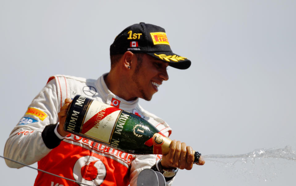 MONTREAL, CANADA - JUNE 10: Lewis Hamilton of Great Britain and McLaren celebrates on the podium after winning the Canadian Formula One Grand Prix at the Circuit Gilles Villeneuve on June 10, 2012 in Montreal, Canada. (Photo by Paul Gilham/Getty Images)