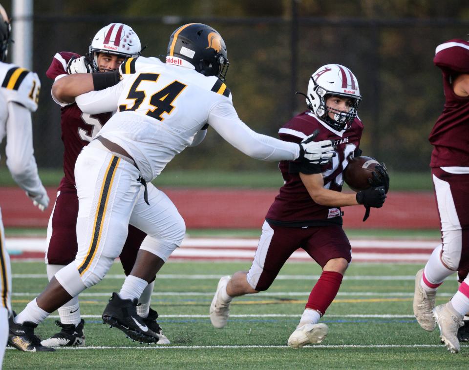 Athena defensive lineman Zayden Walters tries to close the hole for Greece Arcadia running back Dominic Zona during a Class A game in 2021.