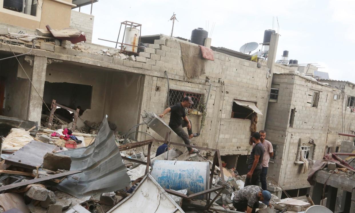 <span>People searching amid the ruins of a house hit by an Israeli airstrike at Nuseirat, Gaza on Monday.</span><span>Photograph: APAImages/Rex/Shutterstock</span>