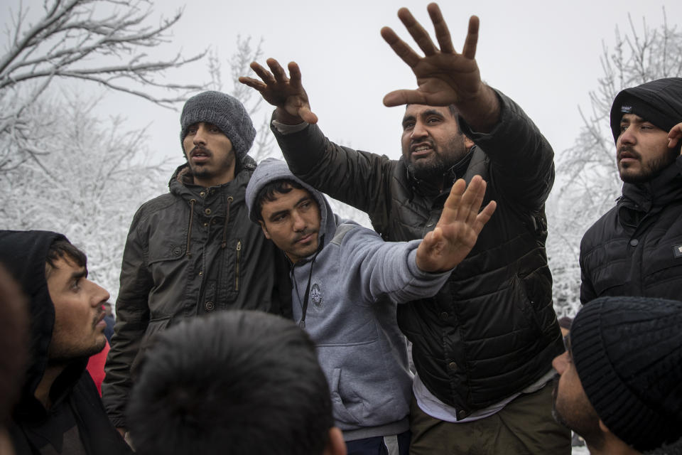 Migrants gather in protest of conditions at the Vucjak refugee camp outside Bihac, northwestern Bosnia, Tuesday, Dec. 3, 2019. Despite calls for their relocation before winter, hundreds of migrants remain stuck in a make-shift tent camp in northwestern Bosnia as a spate of snowy and cold weather hit the region. (AP Photo/Darko Bandic)
