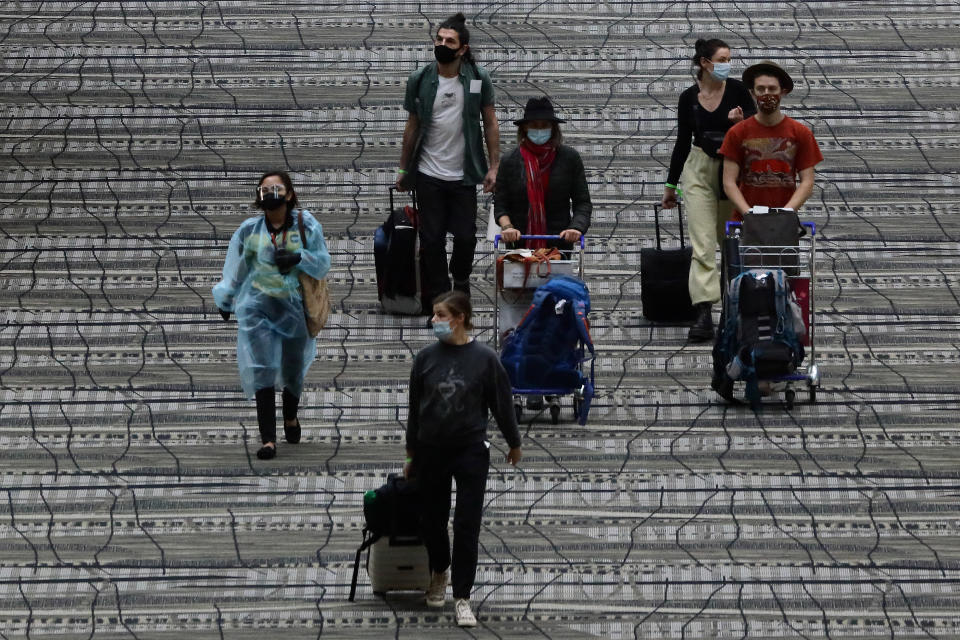 Travellers wearing protective masks seen at Changi Airport on 15 December 2020. (PHOTO: Getty Images)