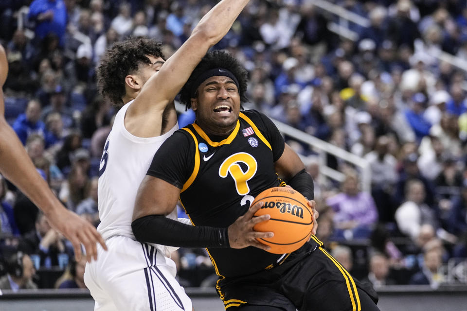 FILE - Pittsburgh forward Blake Hinson (2) drives against Xavier guard Colby Jones (3) during the second half of a second-round college basketball game in the NCAA Tournament on Sunday, March 19, 2023, in Greensboro, N.C. Pittsburgh opens their season Nov. 7 at home against Yale. (AP Photo/John Bazemore, File)