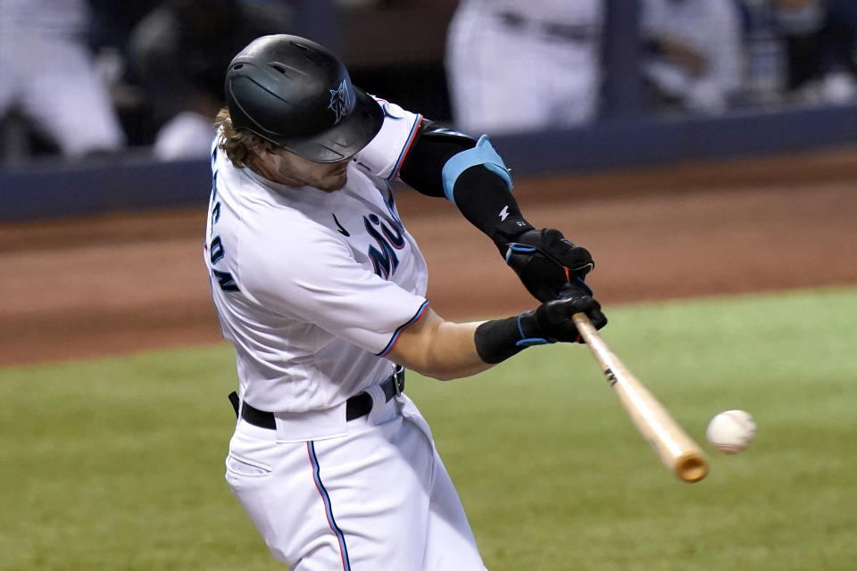 Miami Marlins' Brian Anderson hits an RBI-single to score Miguel Rojas during the first inning of a baseball game against the Arizona Diamondbacks, Wednesday, May 5, 2021, in Miami. (AP Photo/Lynne Sladky)